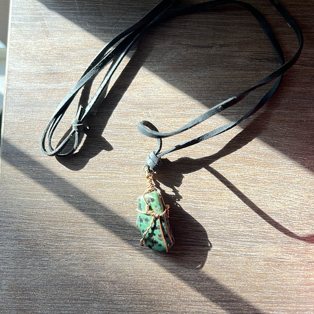 Wire wrapped zoisite necklace with black leather cord.